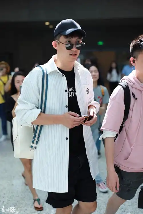 黄景瑜穿白条纹衬衫搭配黑短裤现身机场,戴棒球帽和墨镜又酷又帅