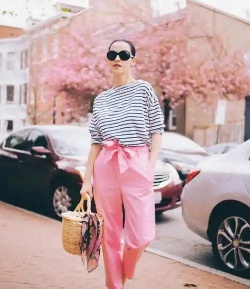 对于肤色不是很白皙的女性来说,选择用粉色的裤子来搭配,整体的造型