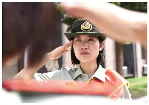 图为一名退伍女兵向战友敬礼.