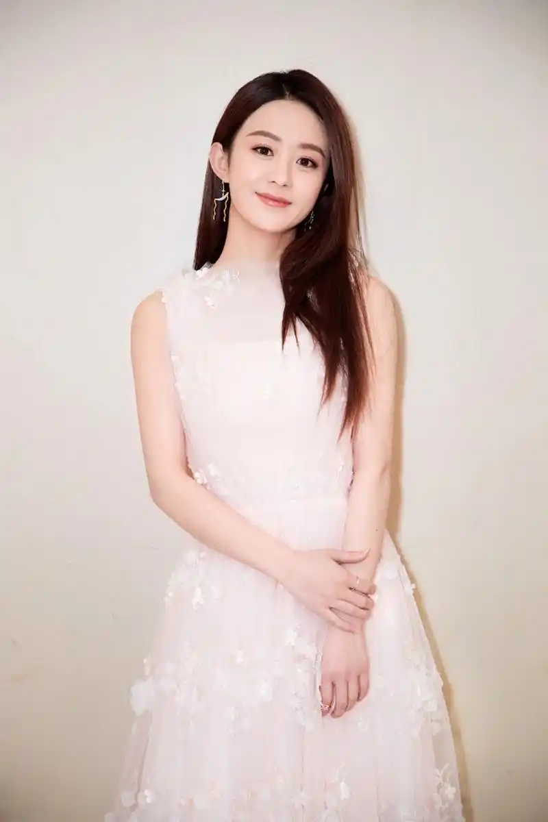 赵丽颖身穿白色长裙,对镜头浅浅微笑,气质动人.