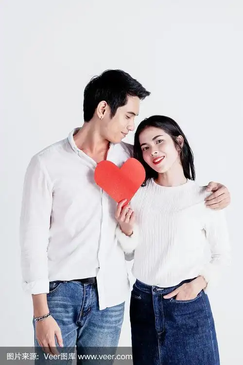 幸福的小两口捧红纸心,爱情故事情人节
